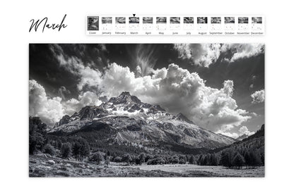 March calendar image displaying a dramatic black and white mountain range under a sky filled with dynamic clouds.