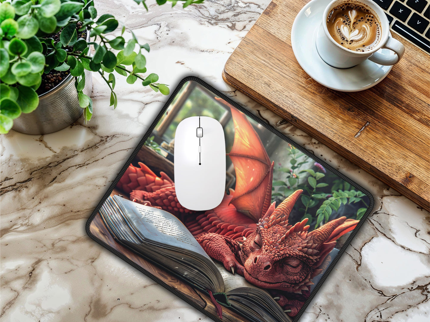 A creative workspace highlighted by a gaming mouse pad with a red dragon resting on an aged book, paired with coffee and modern gadgets