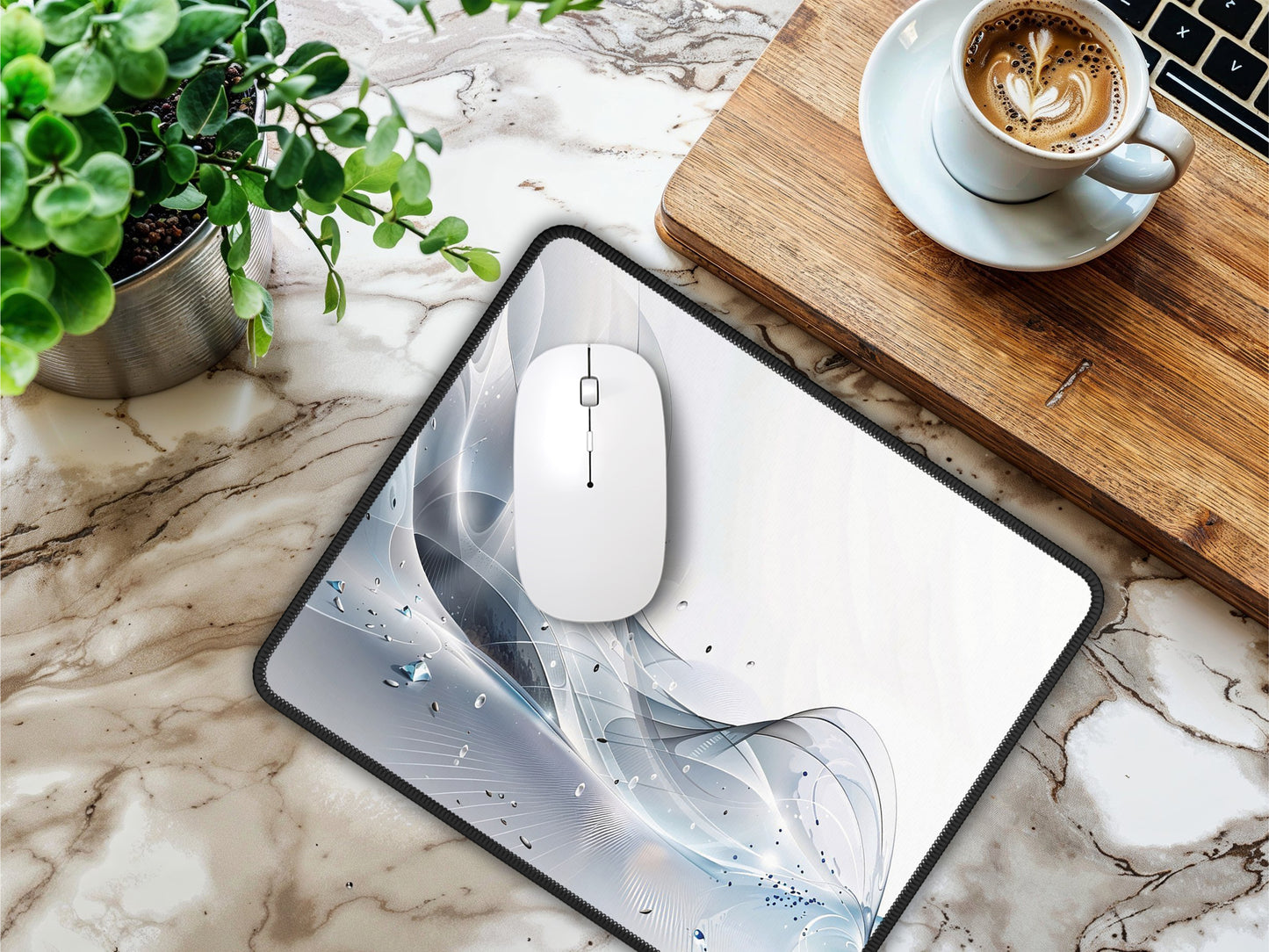 The mouse pad on a marble table, next to a plant, wooden tray, and coffee cup, exuding a modern vibe.