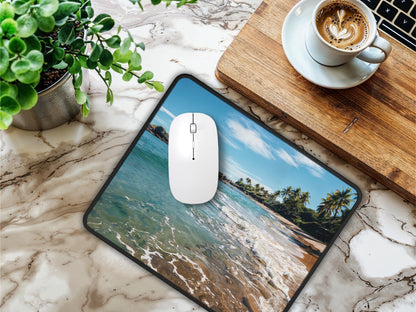 Desk setting with the Thai beach mouse pad situated on a marble tabletop, offering a refreshing workspace alongside a cup of coffee.