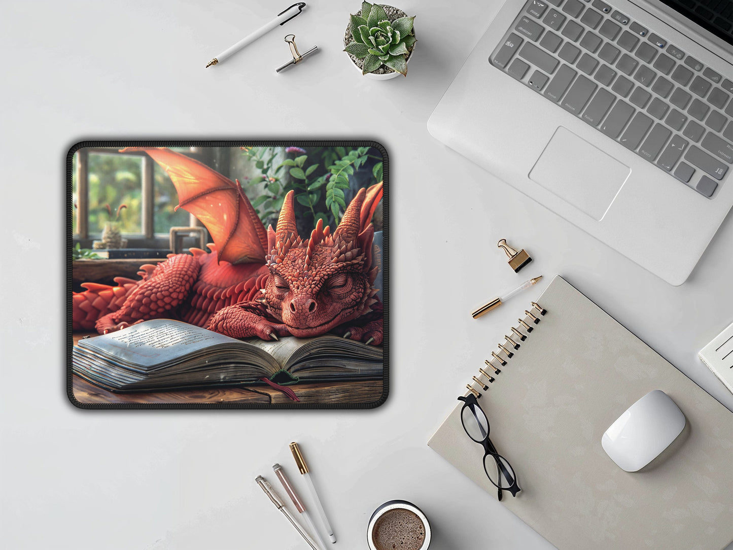 An office setup is enhanced by a small, enchanting mouse pad, where a red dragon dozes on a tome, adding a touch of fantasy to the desk.