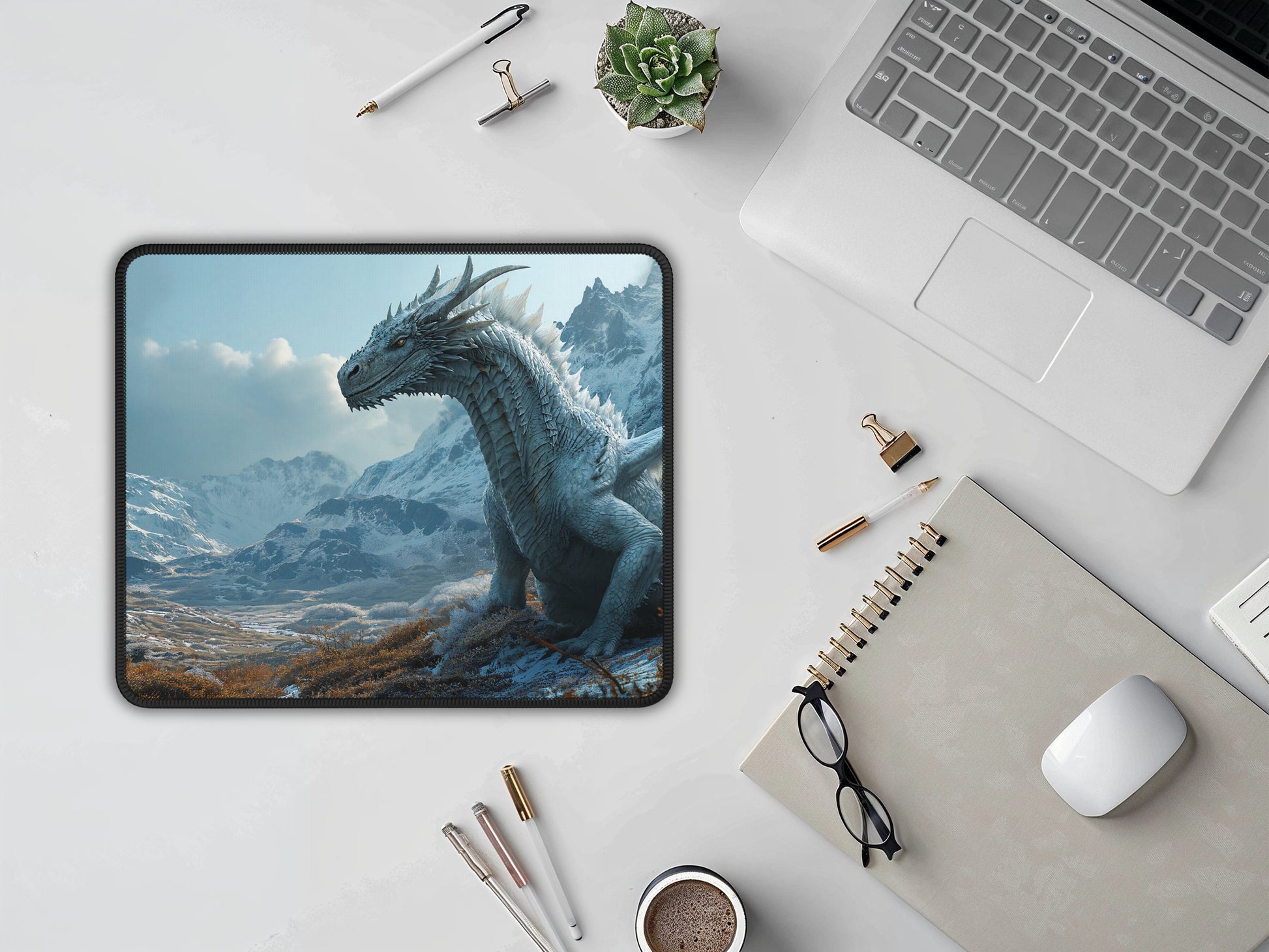 The mouse pad displayed in a professional setup, its fantastical dragon imagery set against the tools of a productive workspace.