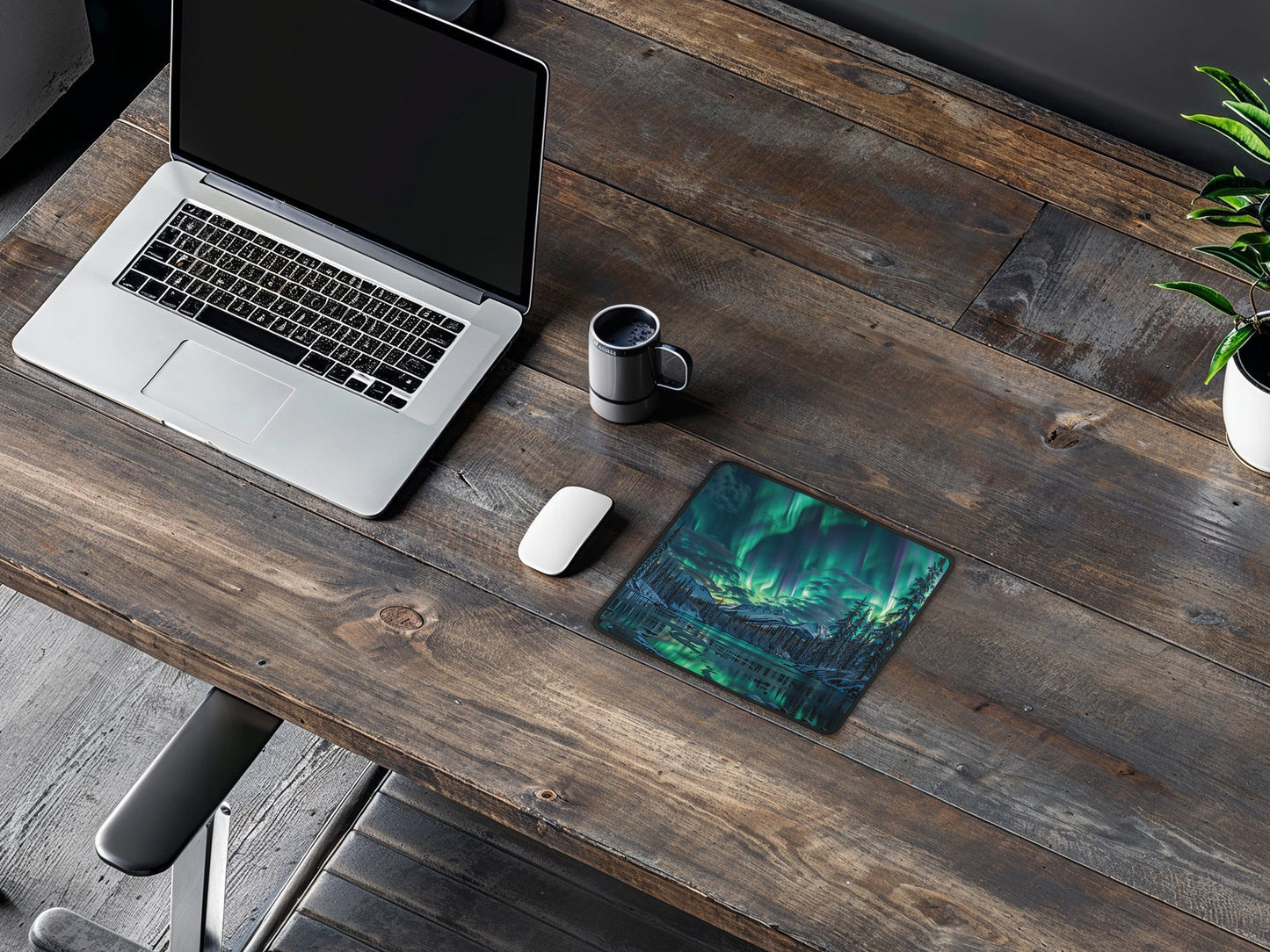 Rustic wooden table with the Alaskan aurora mouse pad, adding a touch of natural wonder to the work area.