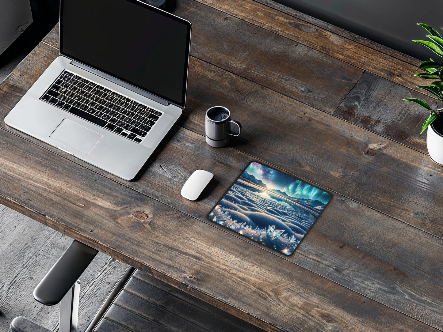 Lifestyle shot of the mouse pad on a wooden table with a laptop, illustrating a functional setup for gaming or office work.