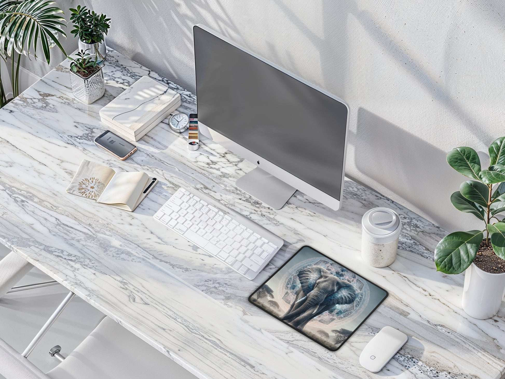 Aerial view of a modern, minimalistic desk space with the majestic elephant mouse pad at its center.