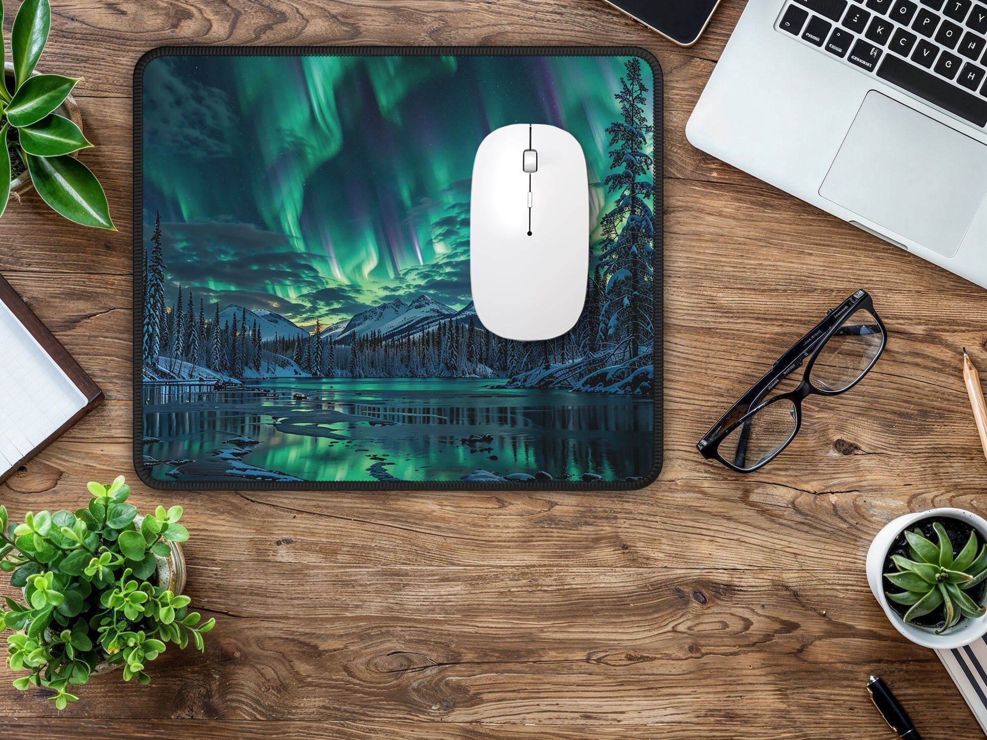 Top view of a home office desk with the Alaskan aurora mouse pad, offering a stunning backdrop for daily tasks.