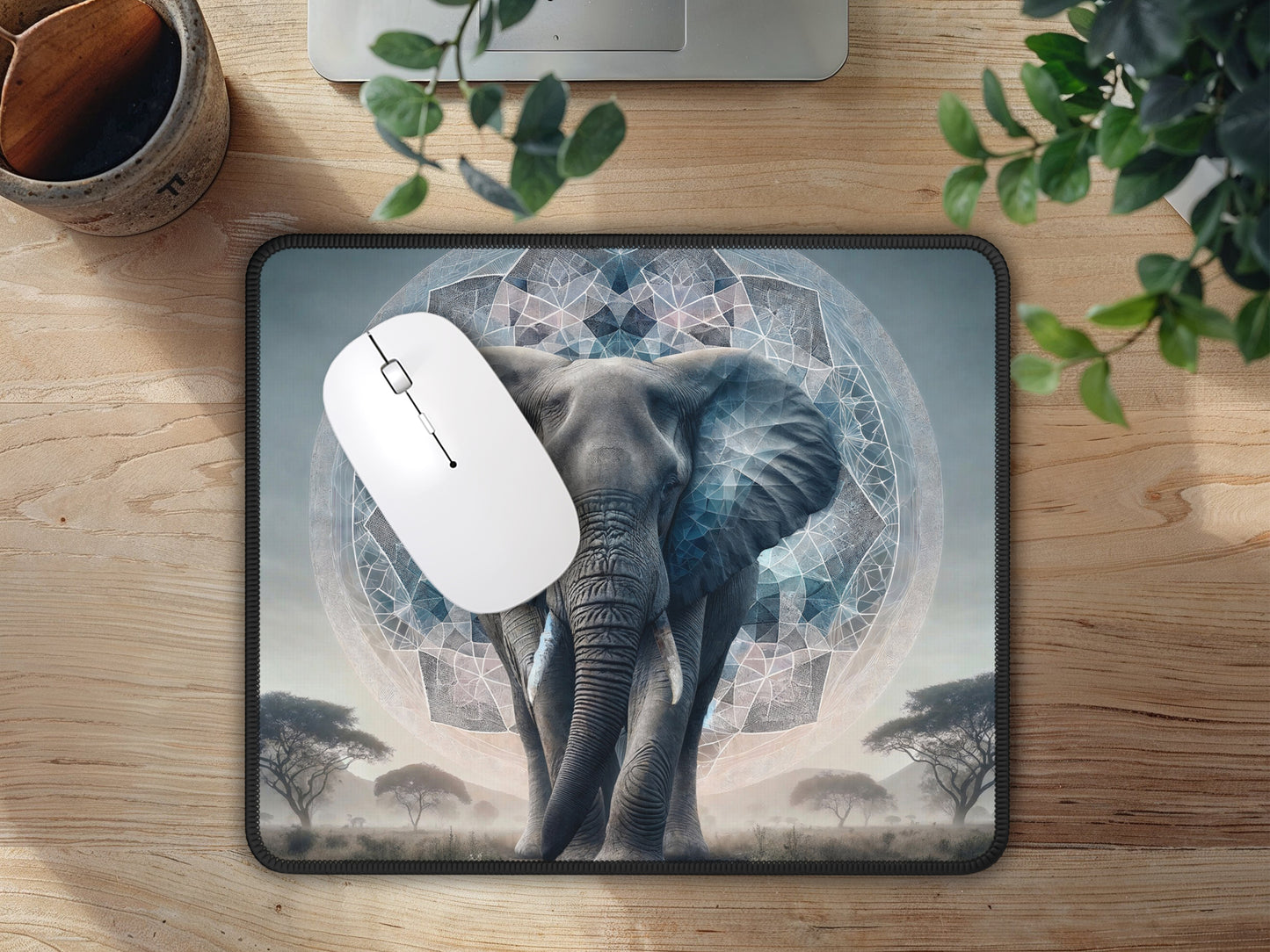 Inviting office space highlighted by the unique kaleidoscope elephant mouse pad, paired with a white mouse and indoor greenery.