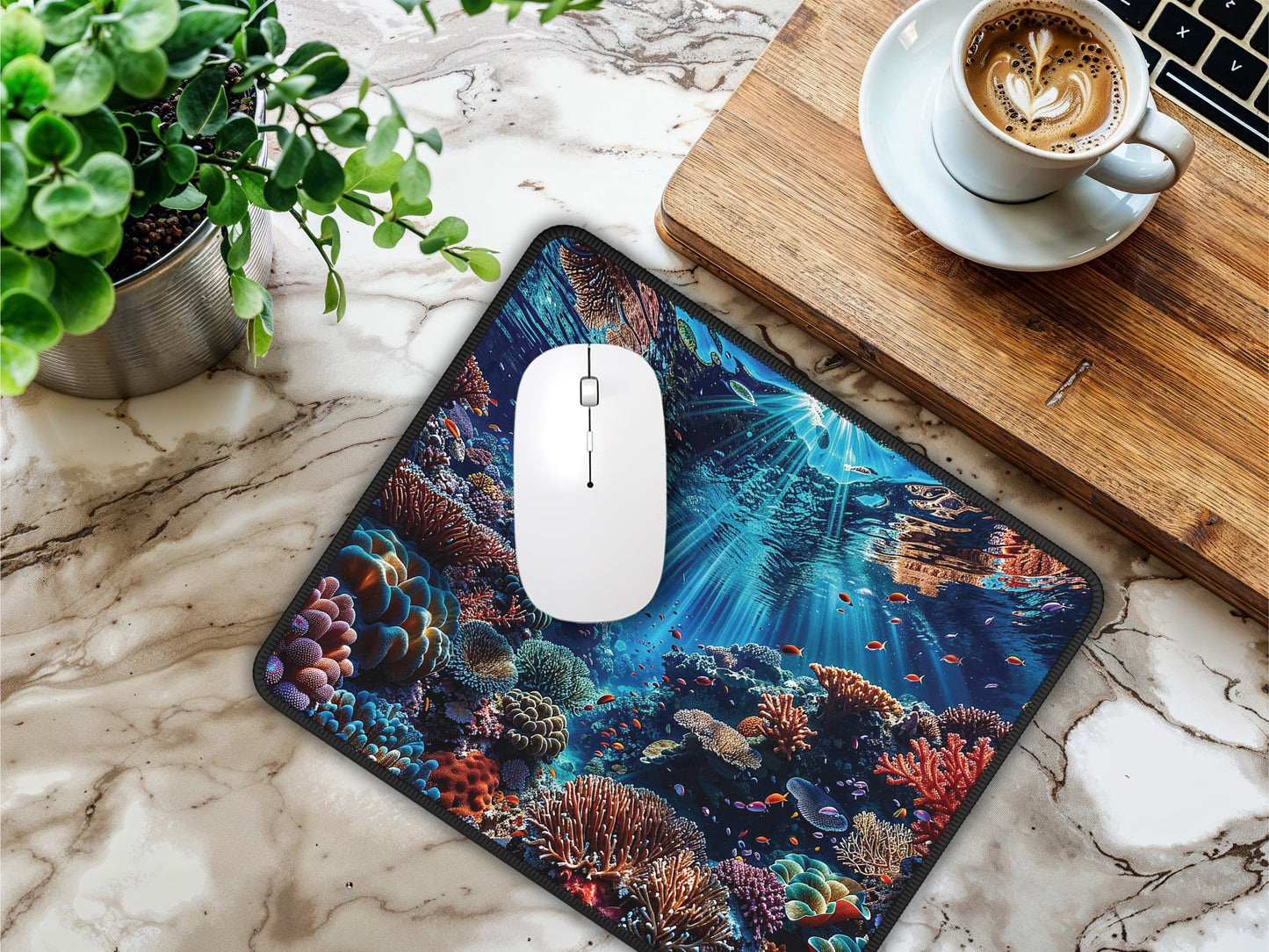 The mouse pad on a marble table with a laptop and coffee cup, bringing the oceans depths to your workspace.