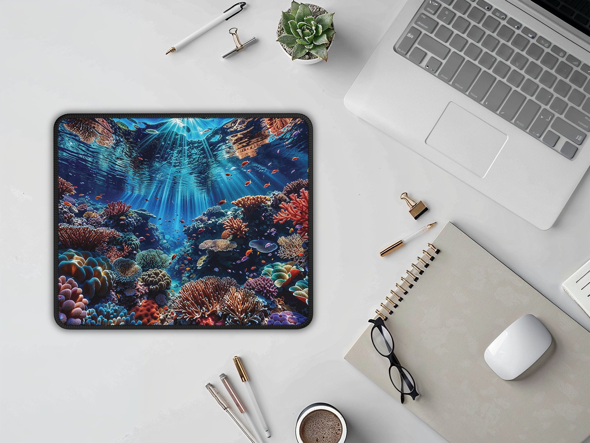 Mouse pad with a sunlit coral reef design creating an inviting and bright atmosphere on a clean, modern desk setup.