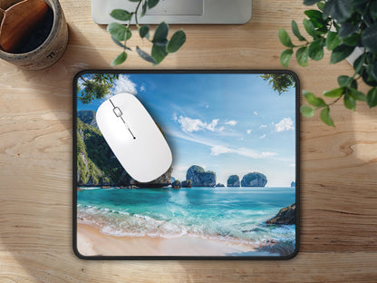 Mouse pad on a home office wood desk, the Thai beach print creating an inviting and peaceful computing environment.