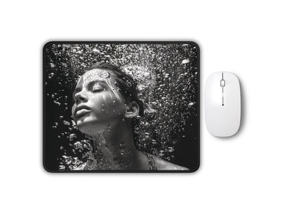 Black and white image of a mouse pad with a photorealistic design of a womans face surrounded by water droplets.