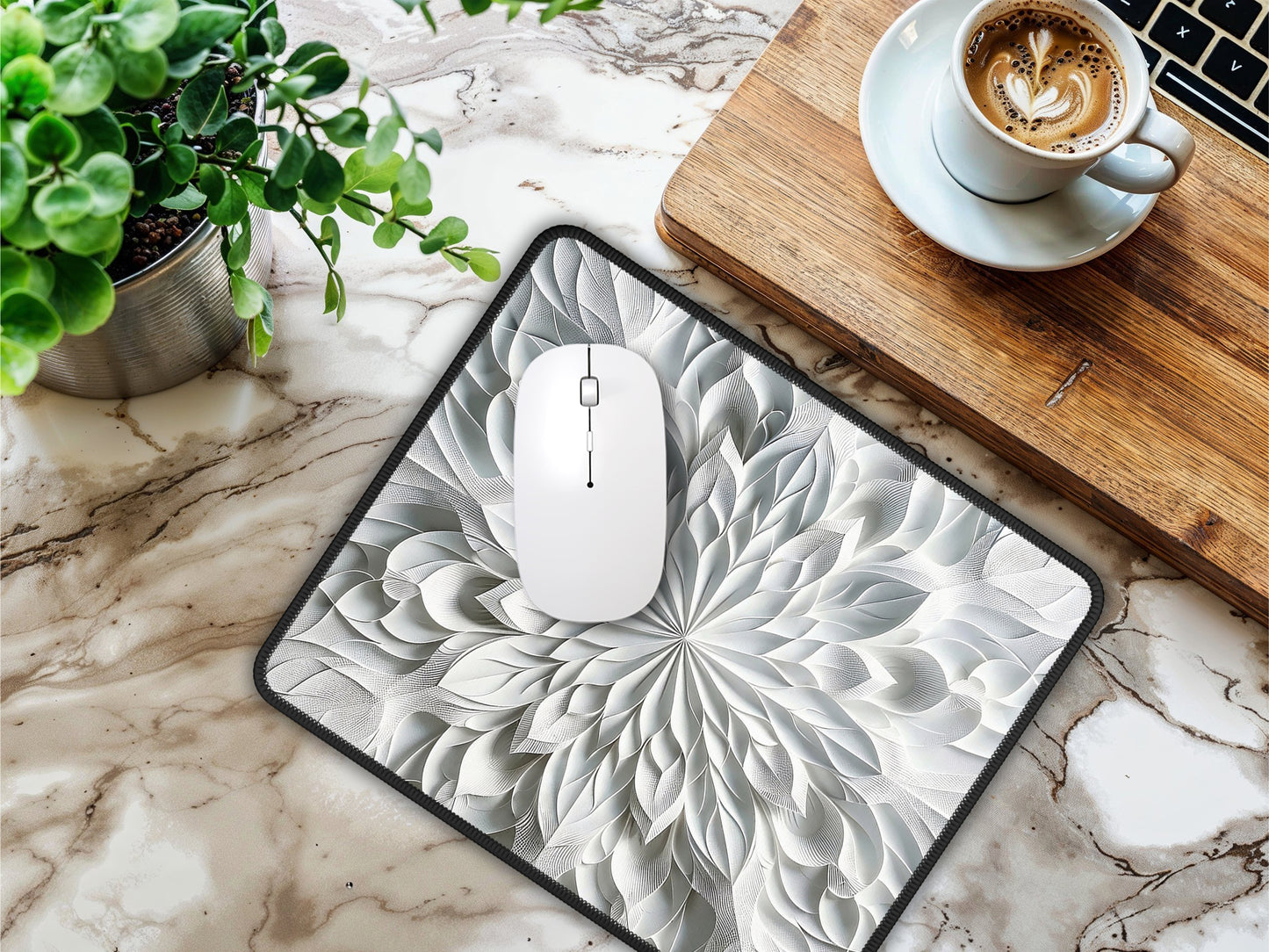 Mouse pad on a marble table with a white mouse, next to a cup of coffee and a laptop, showcasing the design.