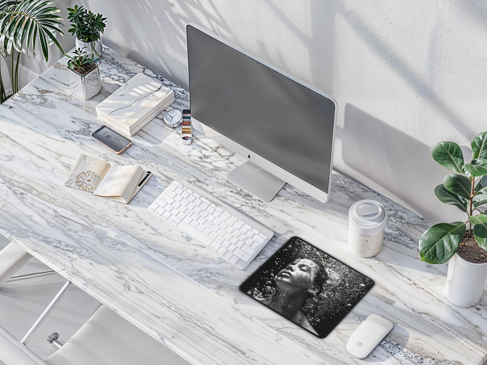 Mouse pad on a clean workspace with a keyboard and plant, depicting a serene underwater scene in grayscale.