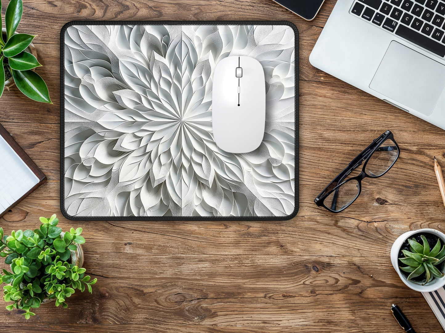 Stylish gaming mouse pad with a detailed grayscale kaleidoscope design, on a home office wooden table.