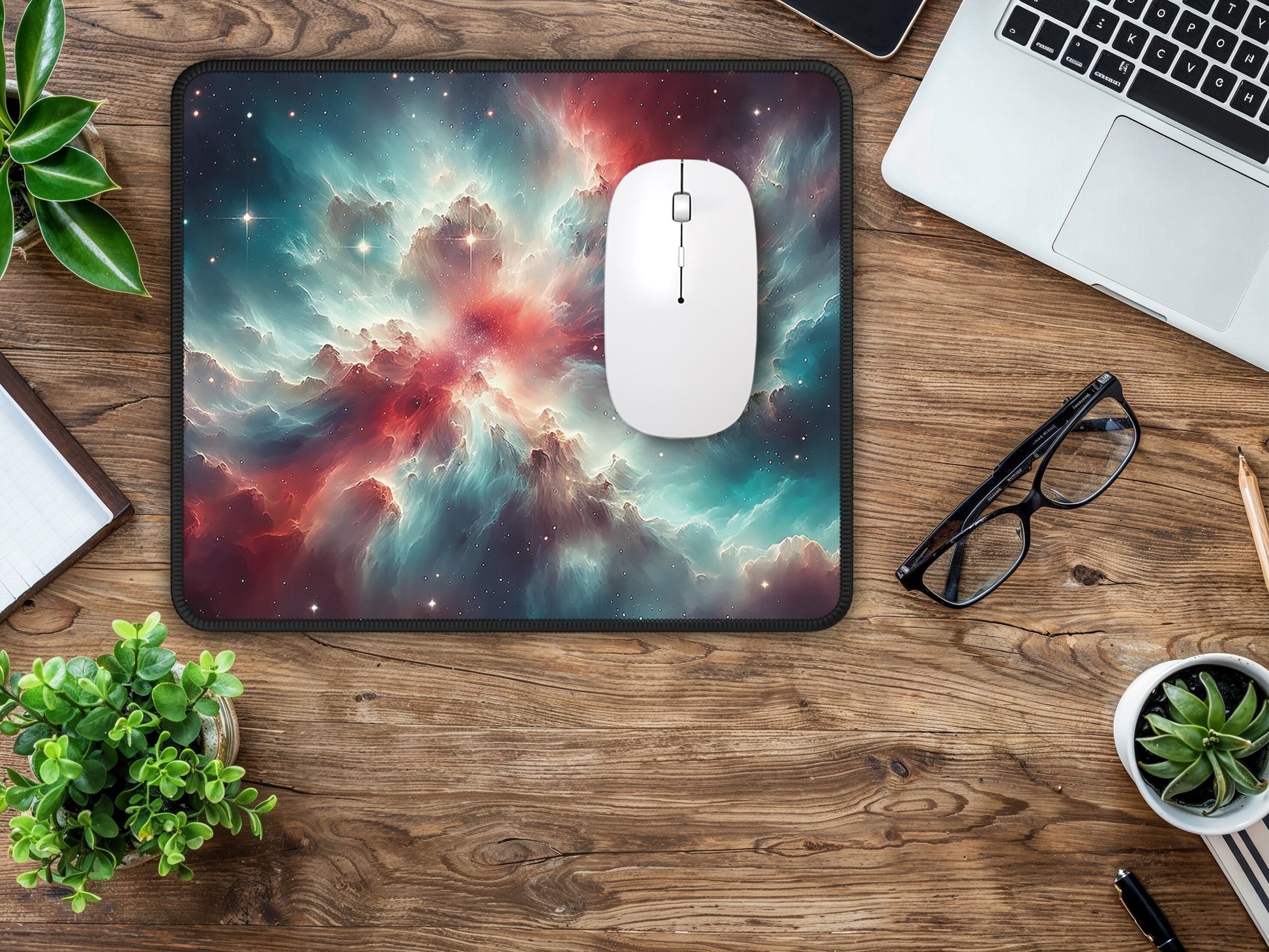 Laptop desk setup enriched with a stunning cosmic Orion Nebula mouse pad, providing an astronomical accent