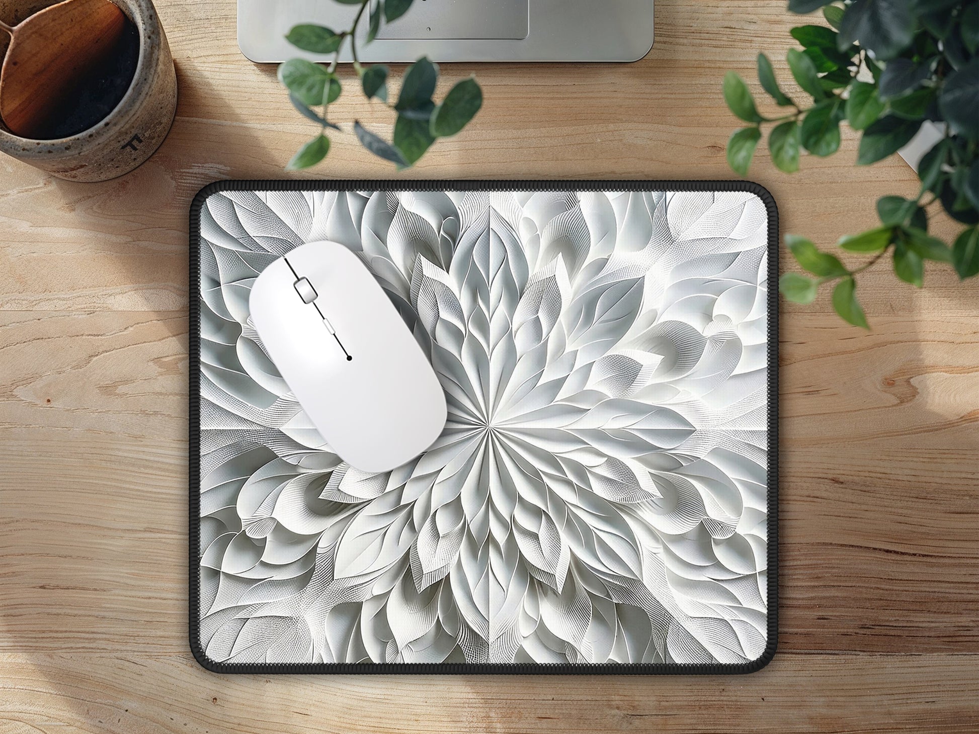 Mouse pad with a 3D kaleidoscope effect in soft grays, placed on a wooden surface, adding elegance to the space.